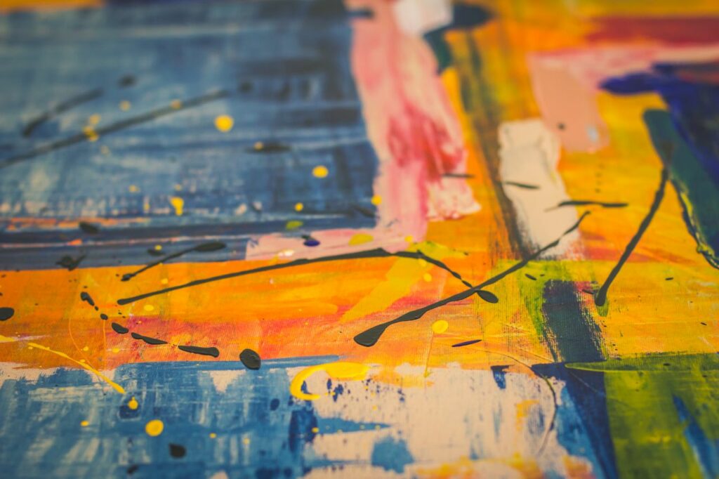 Dynamic abstract painting with vivid colors and textured brushstrokes on canvas, showcasing modern artistic expression.