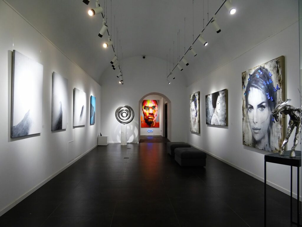 Sleek and modern art gallery with various contemporary paintings on display.
