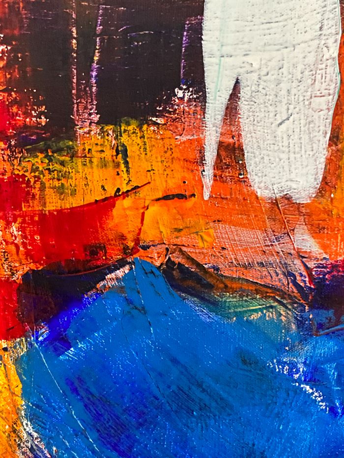 A stunning abstract painting featuring bold red, blue, and orange hues with dynamic textures.