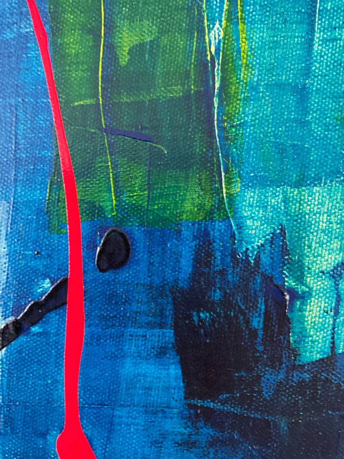 Dynamic abstract artwork featuring bold blue, green, and red hues with textured paint effects.